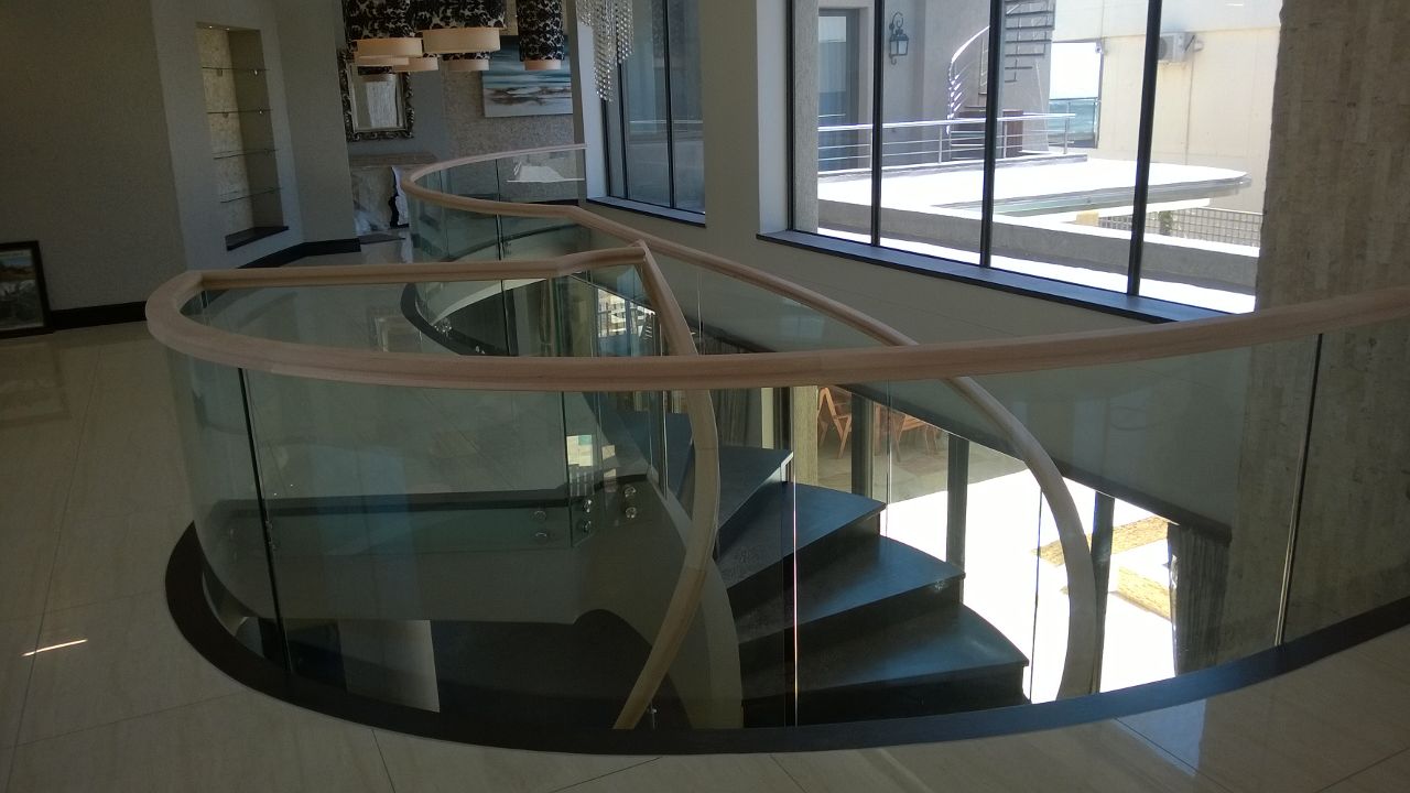 Glass balustrades with hand made wooden handrails. 
